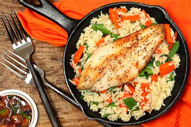 Cooked Catfish In Cast Iron Skillet Pan.