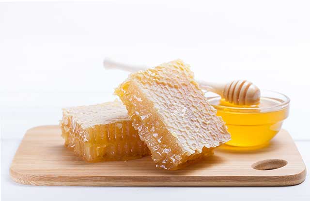 Pieces of Honeycomb, a Bowl of Honey and Honey Dipper.