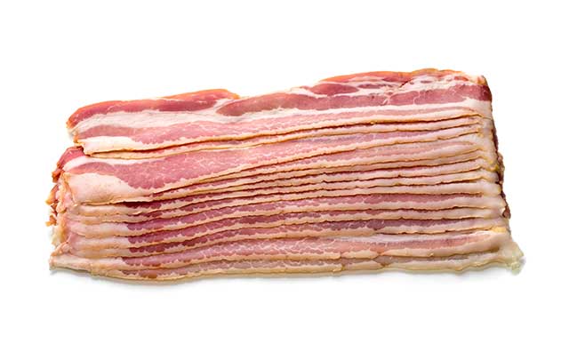 Uncooked Slices of Bacon In a Big Pile.