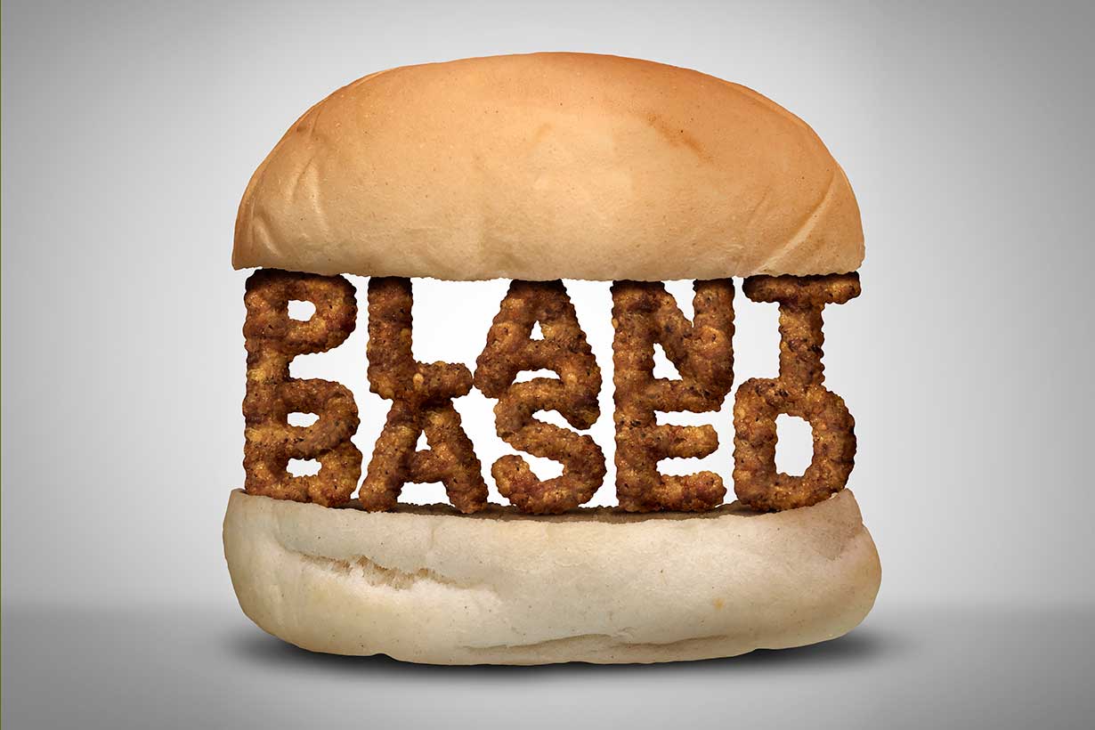 Two Burger Buns With Plant-Based Foods Spelling 'Plant Based' Inside the Buns..