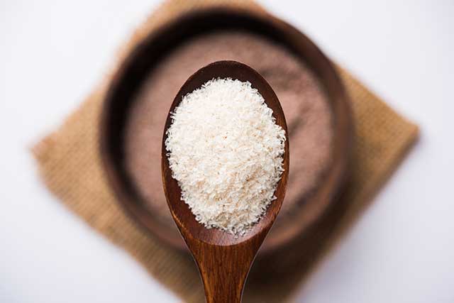 Psyllium Husk Fiber Supplement On a Wooden Spoon.