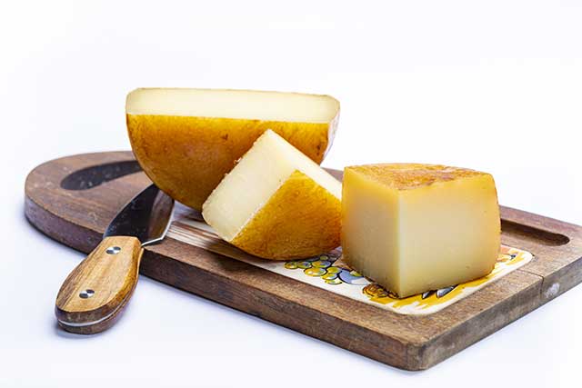 Hard Italian Cheeses On a Wooden Board.