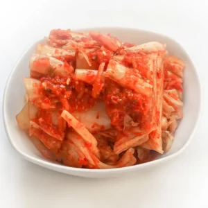 Kimchi served as a side dish in a small white dish.