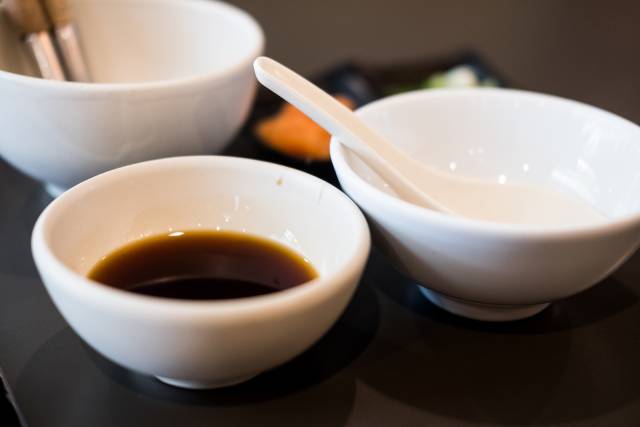 Ponzu sauce in a small white bowl.