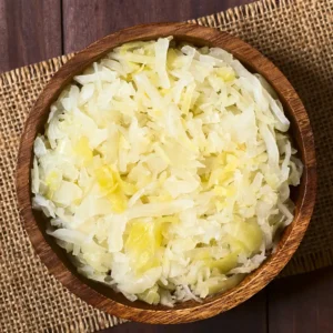 A wooden bowl of sauerkraut (fermented cabbage).