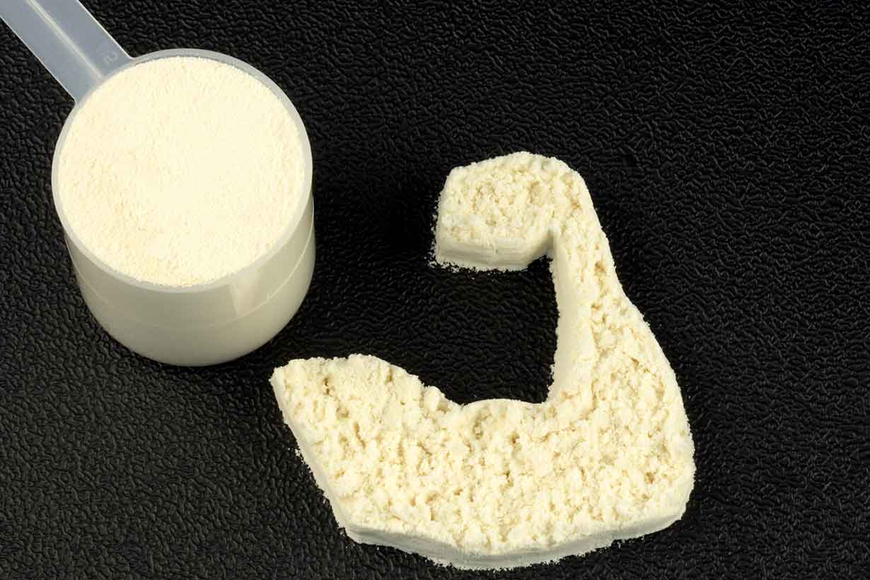 Whey Protein Powder Making the Shape of a Bicep.