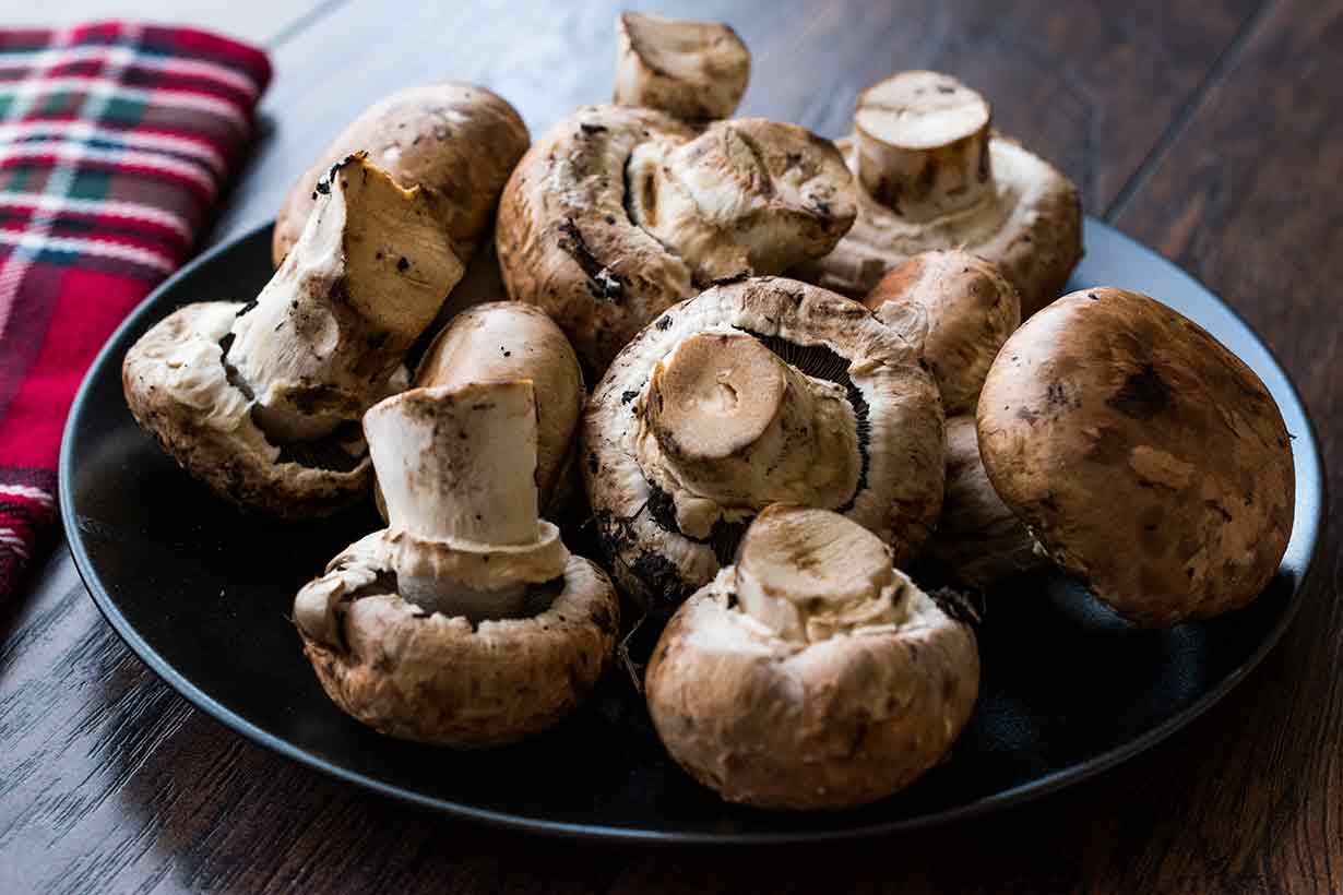 A Pile of Cremini Mushrooms On a Plate.