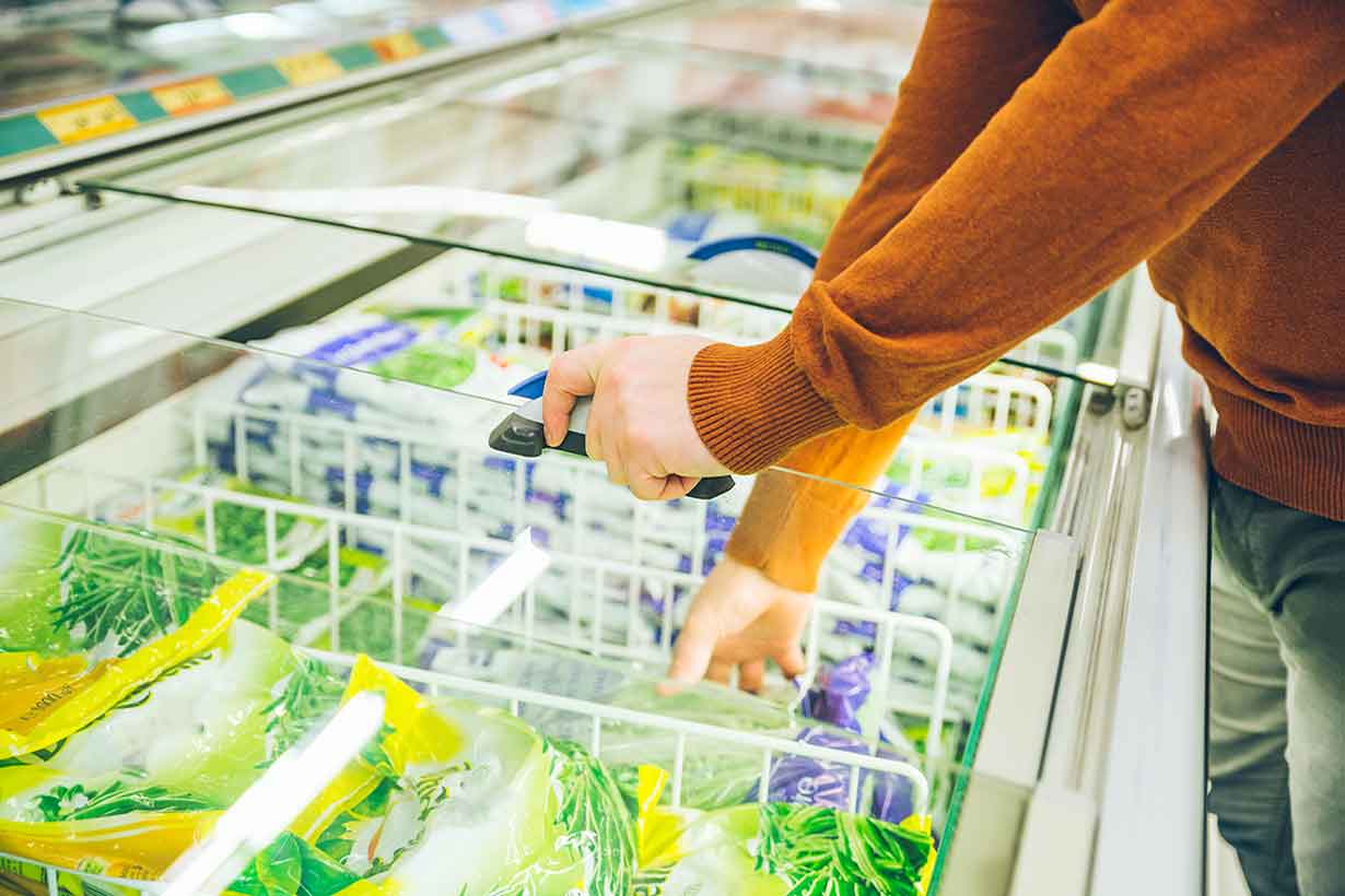 A Shopper Looking At Frozen Foods.