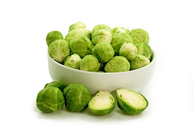 Green Brussels Sprouts in a White Bowl.