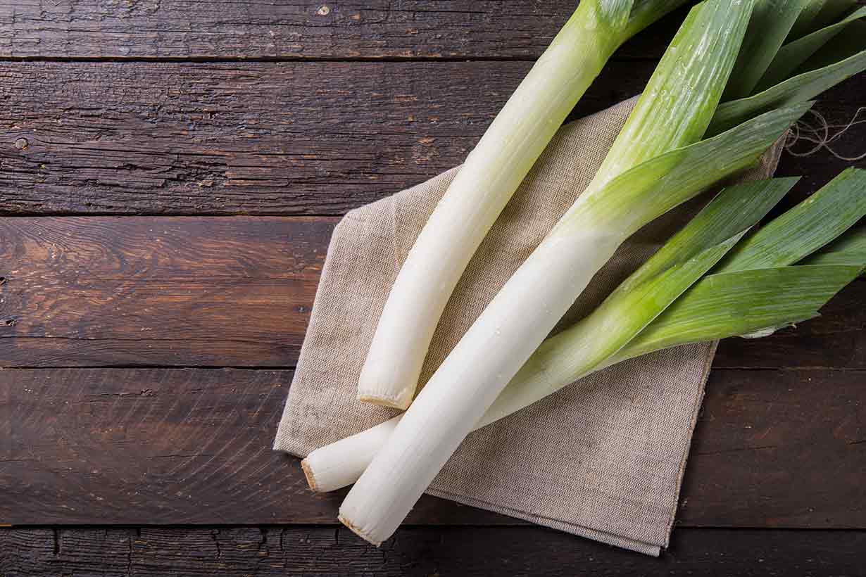 Leeks On a Wooden Table.