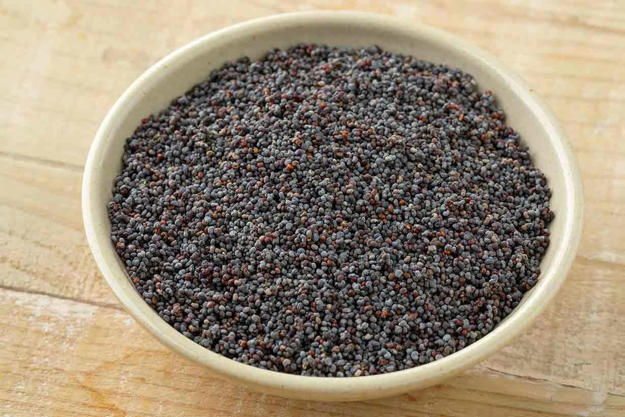 Black Poppy Seeds In a White Bowl.