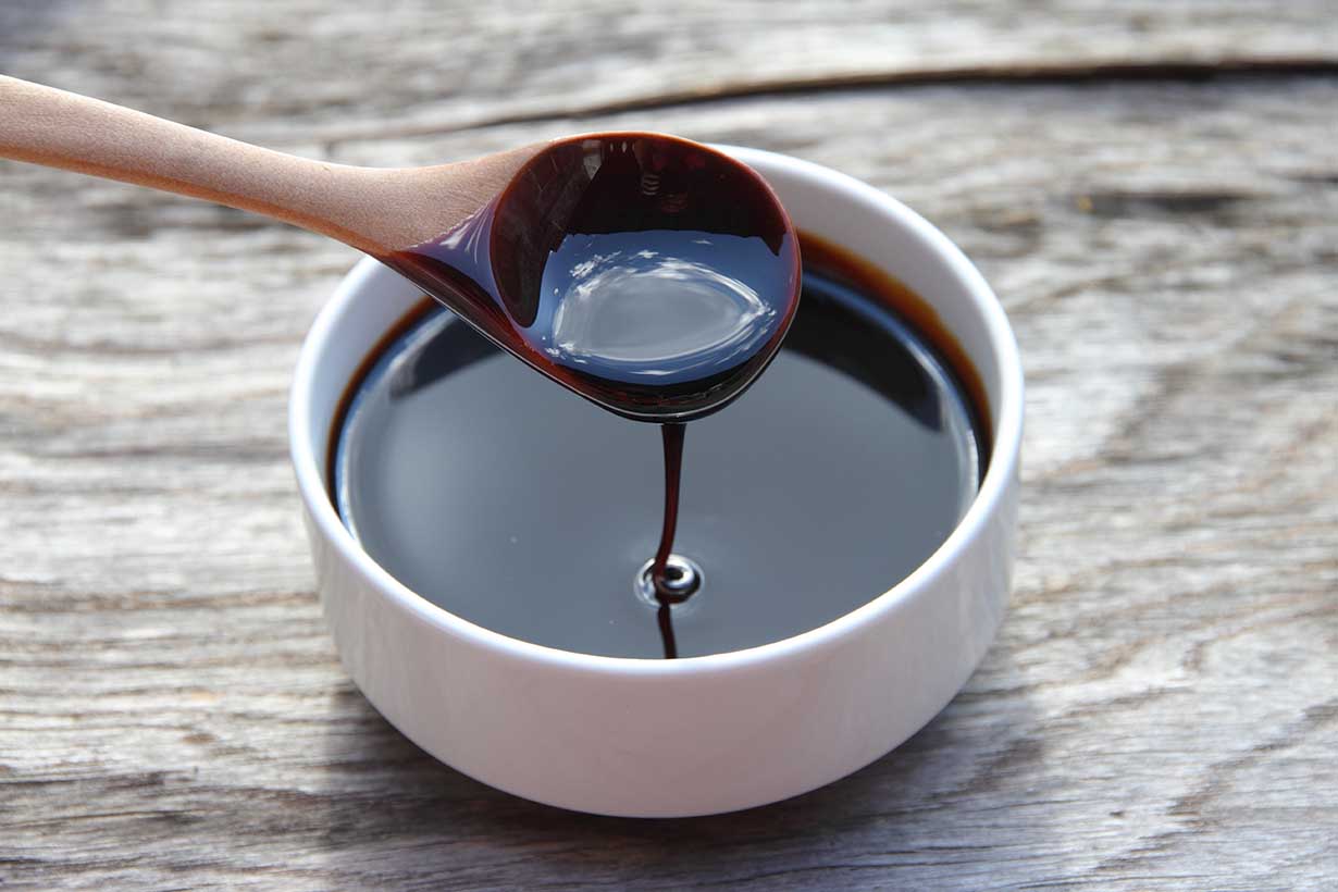 A Bowl of Molasses With a Spoon In It.