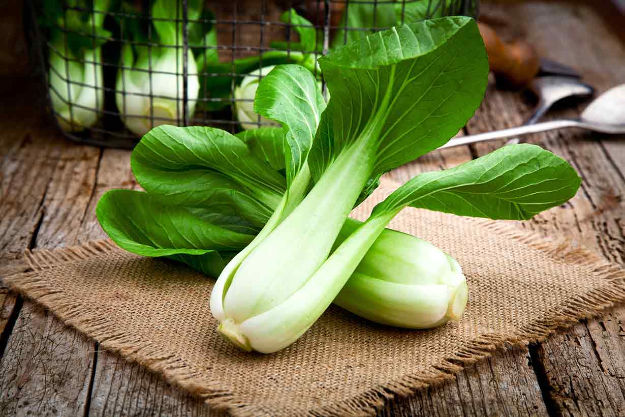 Bok Choy On a Mat On a Wooden Table.