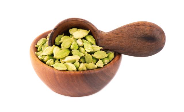 Cardamom Seeds In a Wooden Bowl.