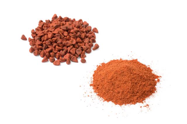 Piles of Annatto Seeds and Annatto Powder.