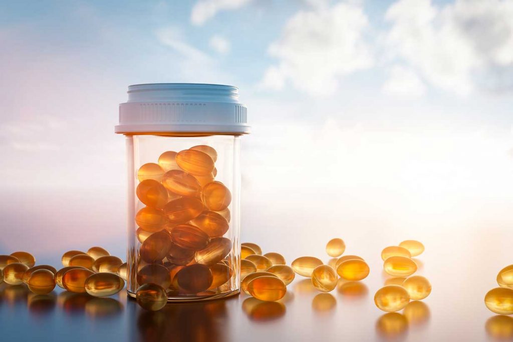 Vitamin D Capsules In a Glass Jar.