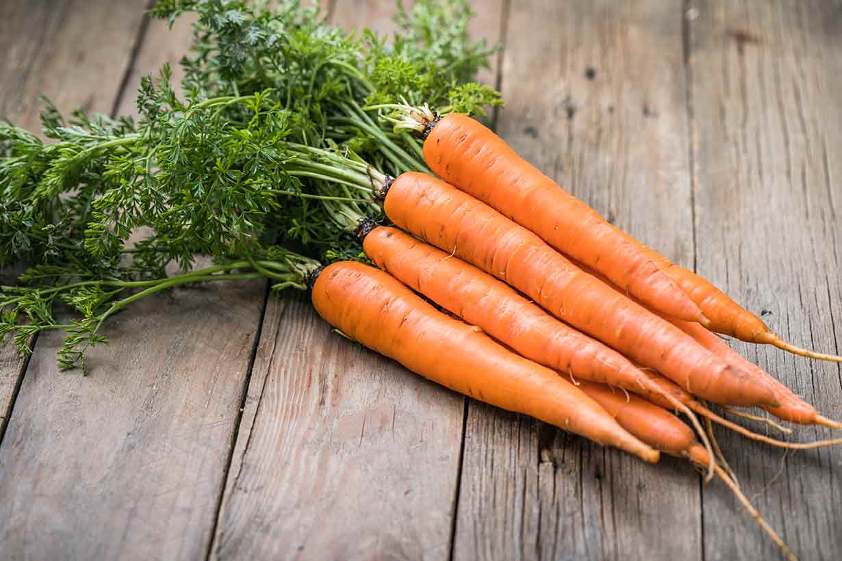 A Bunch of Carrots On a Wooden Surface.