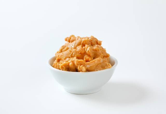 A Small White Bowl of Crunchy Peanut Butter.