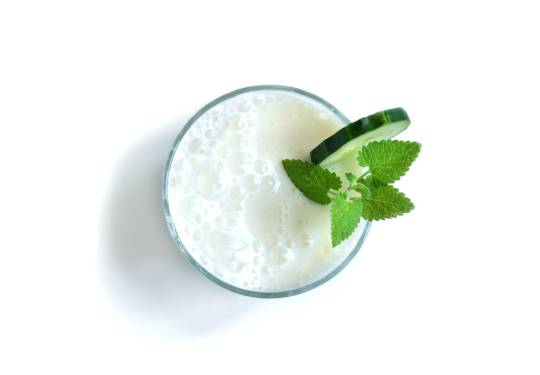 Ayran Yogurt Drink In a Glass With Mint Leaf and Cucumber Slice.