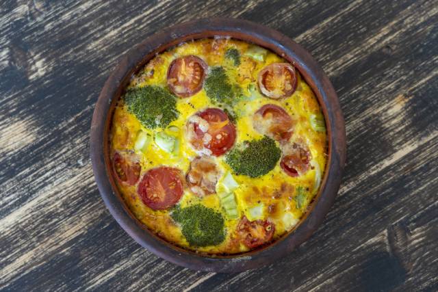 A vegetable frittata in a ceramic bowl.