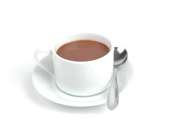 Hot chocolate in a white cup on a saucer with a teaspoon.