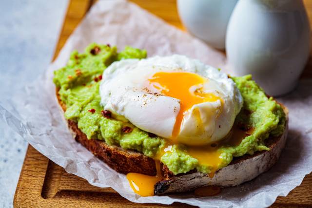 Poached egg on top of avocado toast.