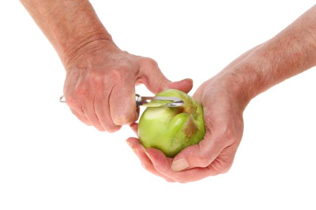 Two Hands Holding a Bramley (Cooking) Apple.