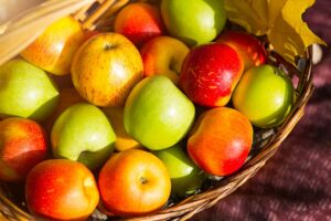 Different Types of Apples In a Straw Basket.