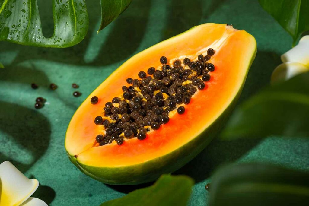 A Papaya Fruit Cut Open Showing Its Flesh and Seeds.