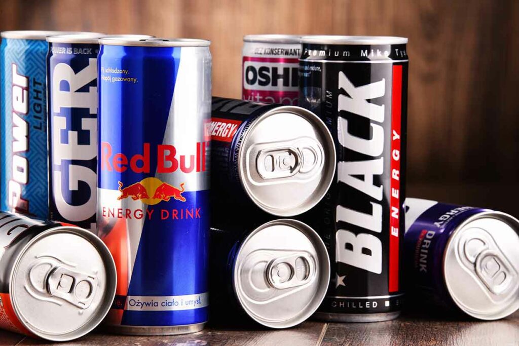 Various Energy Drink Cans Including Red Bull and Black Energy.