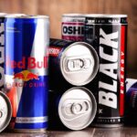 Various Energy Drink Cans Including Red Bull and Black Energy.