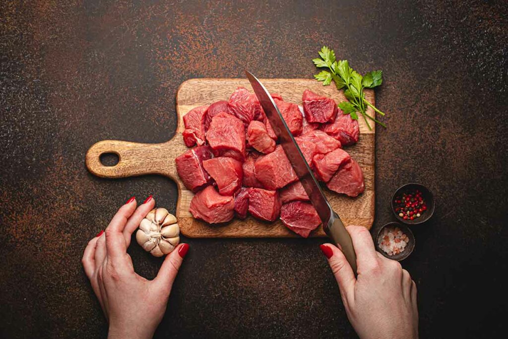 Diced Lean Meat On Chopping Board.