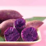 Purple Sweet Potatoes - Whole and Cut Open Showing Their Flesh.