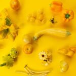 Various yellow vegetables on a yellow background.