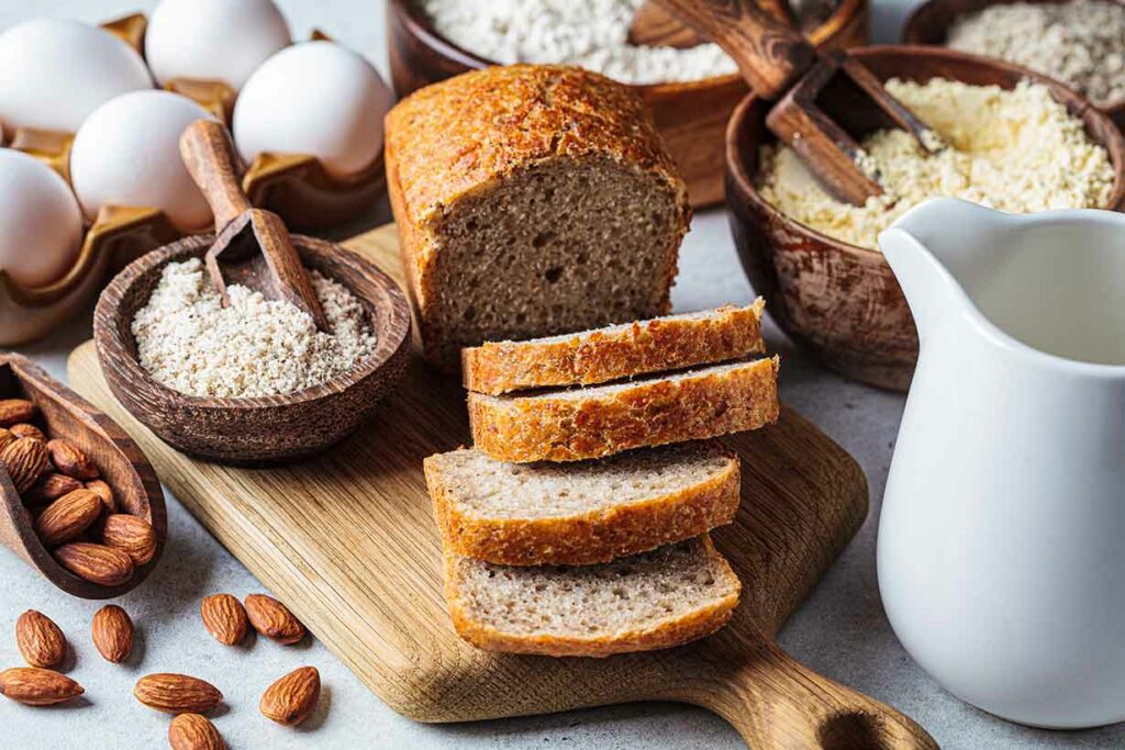 A Loaf of Bread and Various Ingredients Used To Make Different Types of Bread.