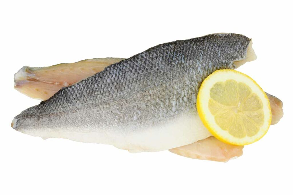 Raw Basa Fish Fillet With a Slice of Lemon.