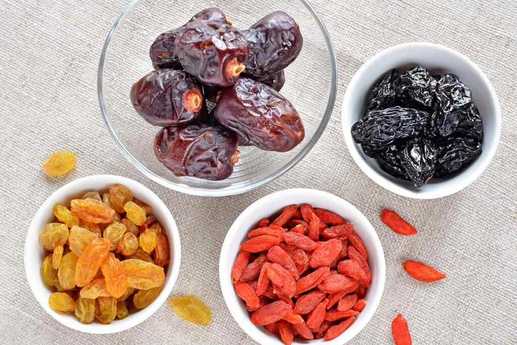 Different Dried Fruits In Small Bowls.