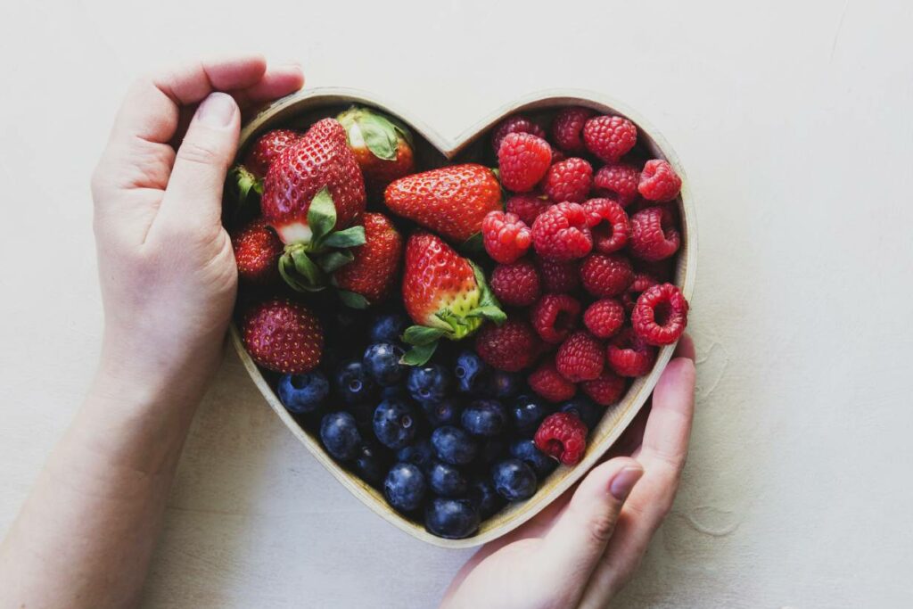 Various Berries In a Heart-Shaped Bowl - Low-Carb Fruit Theme.