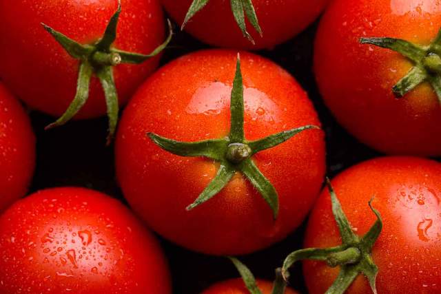 Whole red tomatoes.