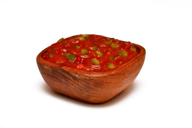 Tomato salsa in a wooden bowl.
