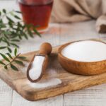 A powdered sweetener in a wooden bowl (erythritol/xylitol).