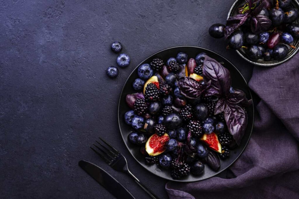 Purple Fruits In Two Bowls.