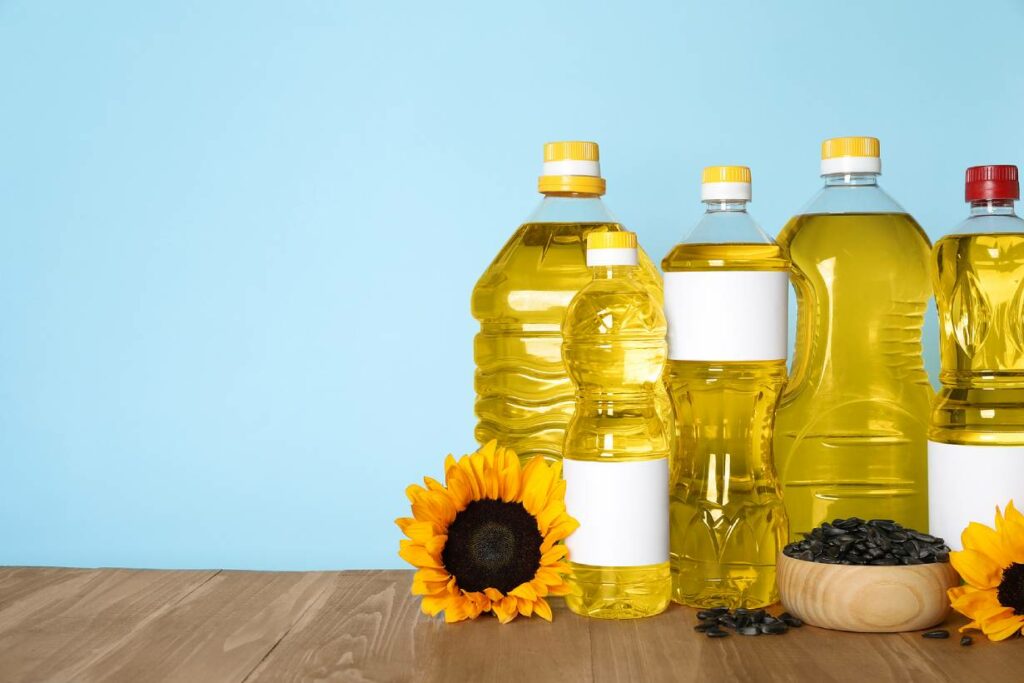 Various Seed Oils In Plastic Bottles On a Wooden Surface.