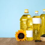 Various Seed Oils In Plastic Bottles On a Wooden Surface.