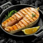 A cooked salmon fillet in a cast iron pan.