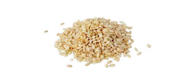 A pile of uncooked brown rice.