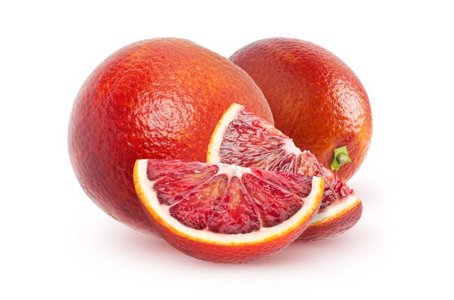 A Blood Orange Next To Two Slices Showing Their Red Flesh.