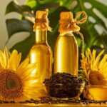 Bottles of high oleic sunflower oil next to two sunflower heads.