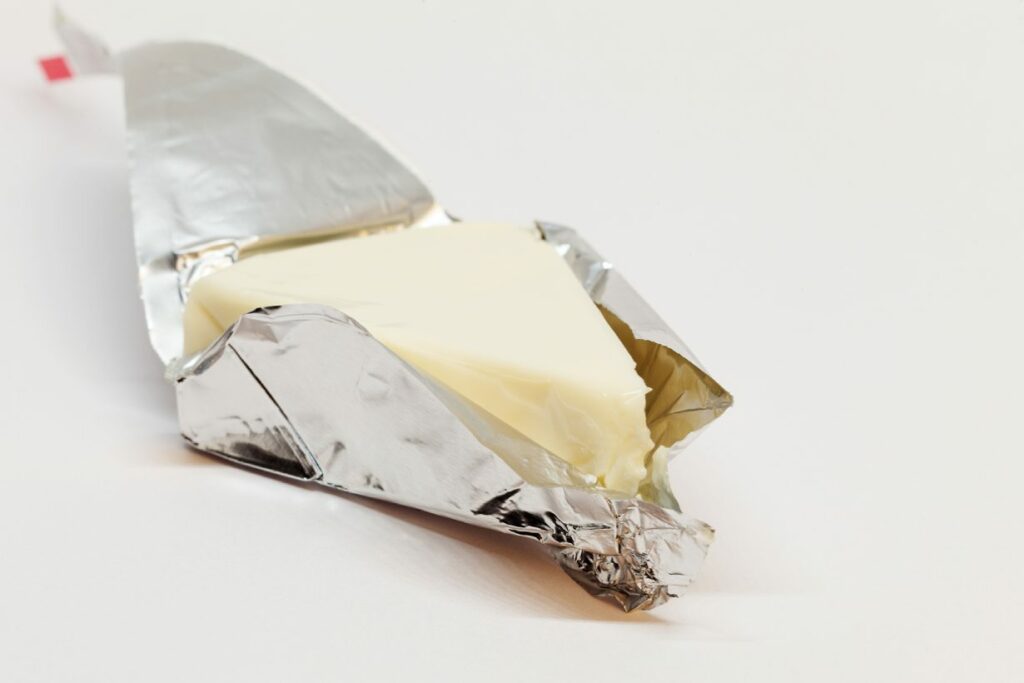 A Triangular Wedge of Laughing Cow Cheese Wrapped In Foil.