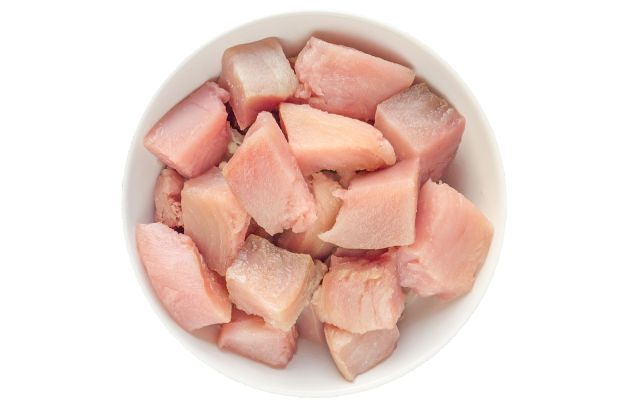 Pieces of albacore tuna in a bowl.